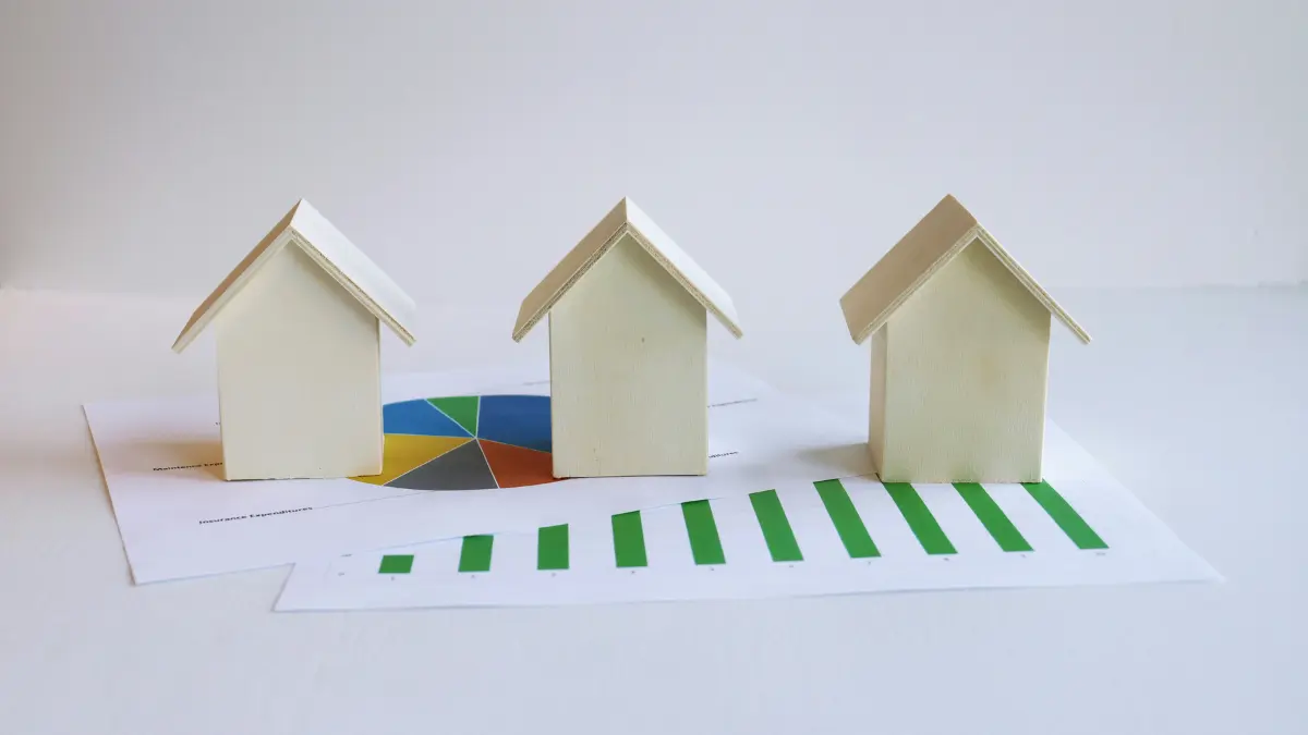 Mortgage comparison concept showing multiple homes placed over financial charts representing different mortgage term choices