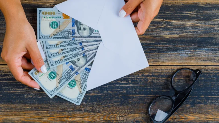 Cash Envelope System featured image showing cash placed inside a budgeting envelope