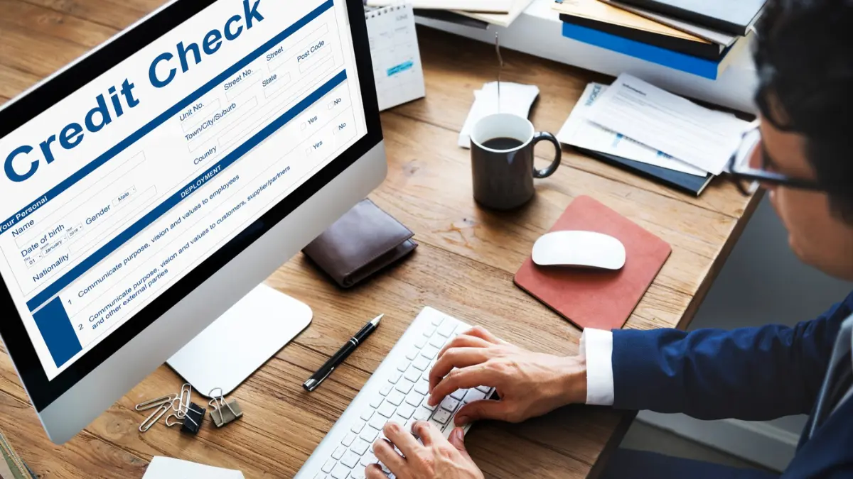 Checking credit score online through a credit report and credit check dashboard on a desktop computer
