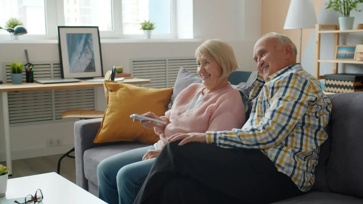 Happy retired couple reviewing retirement income from an Annuity at home