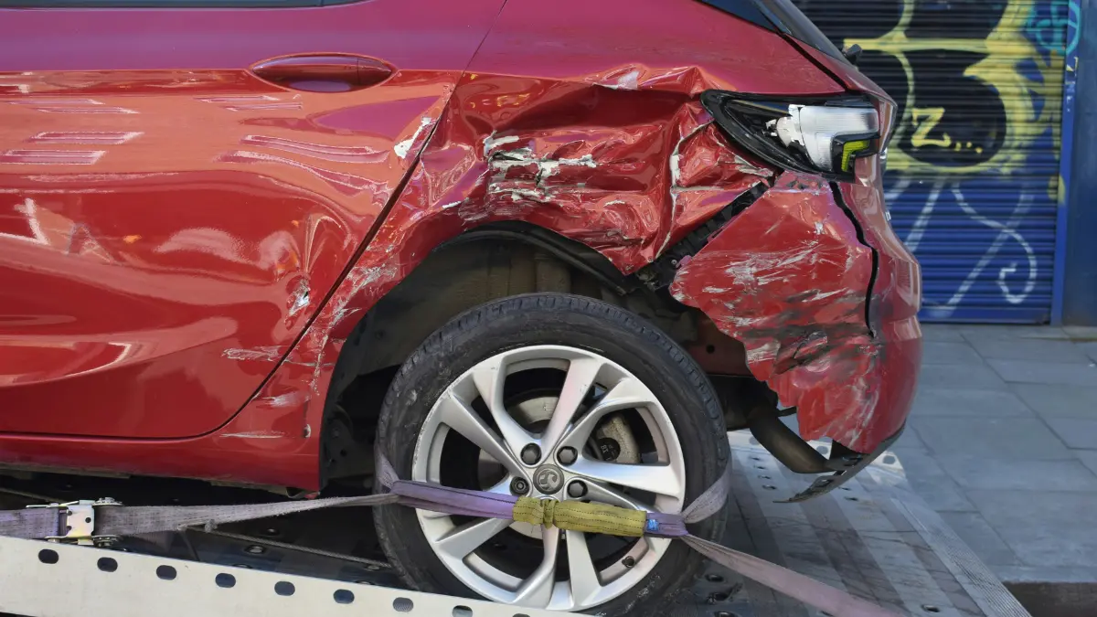 Car Insurance accident damage example showing a red car with severe side impact used to explain coverage and claims