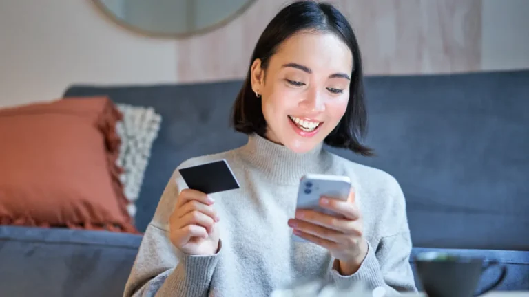 Woman using smartphone for EFTPS alternative digital tax payment in 2026 transition