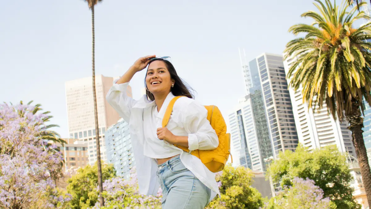 Student walking confidently in city with backpack representing FAFSA 2026 college financial aid success