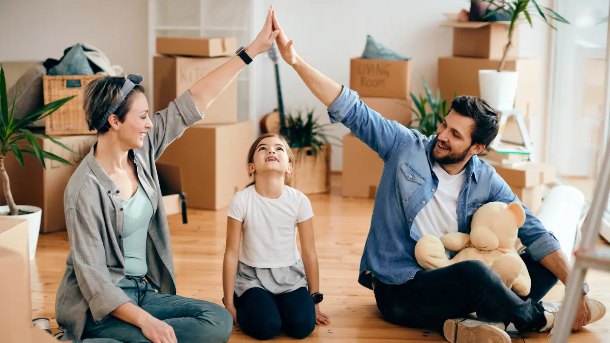 Family celebrating in new home representing home Insurance protection