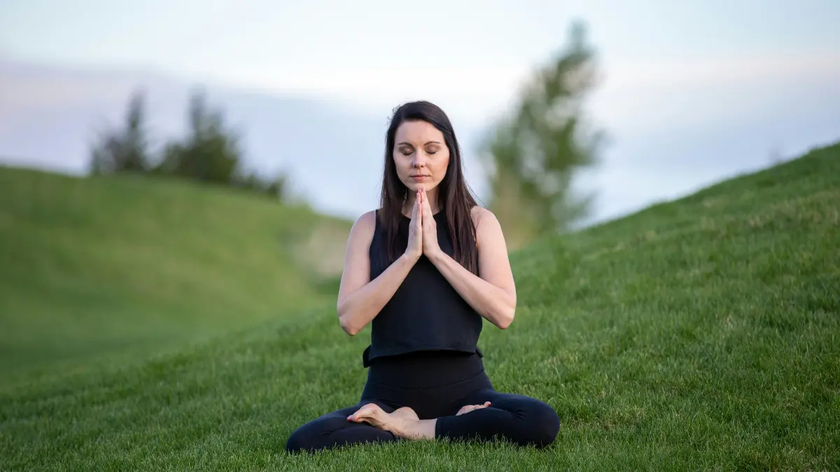 Woman meditating outdoors representing peace of mind with a Medicare Advantage Plan in 2026