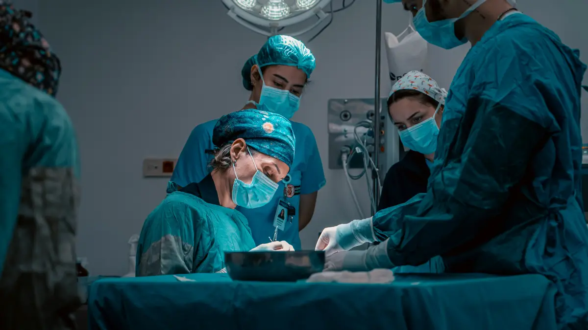 Surgeons performing an operation in a private hospital operating room covered by Private Medical Insurance
