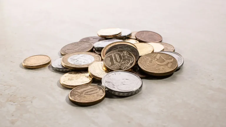 Pile of coins symbolizing monthly savings achieved through lower Refi Rates