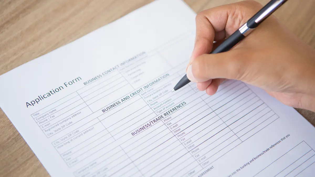 W4 form being filled out by an employee on a desk for tax withholding in 2026