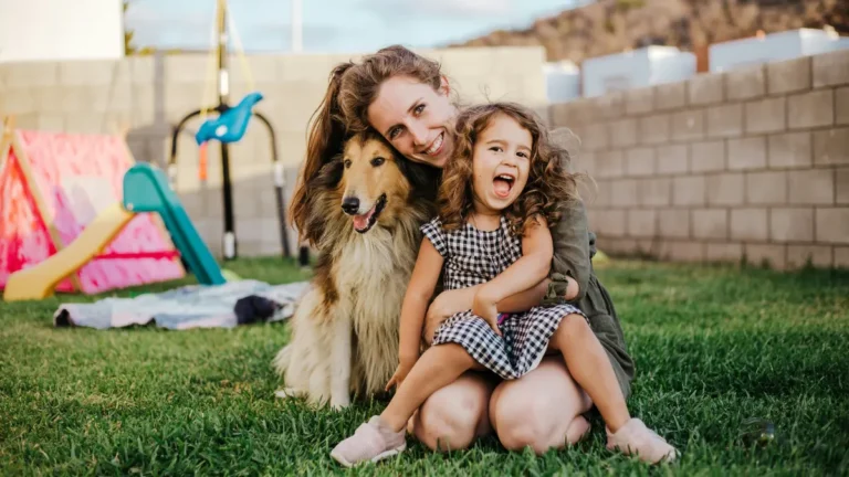 Mother and daughter hugging dog in backyard representing family protection with Whole life insurance