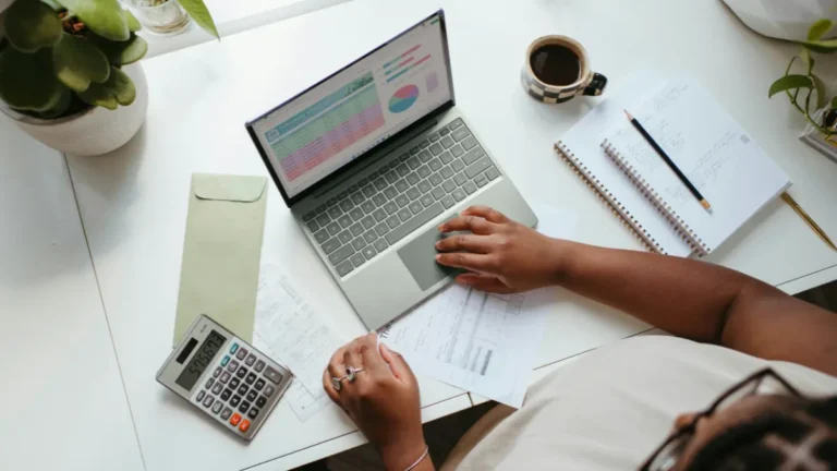 Budget Calculator used for planning monthly finances with laptop calculator and expense documents
