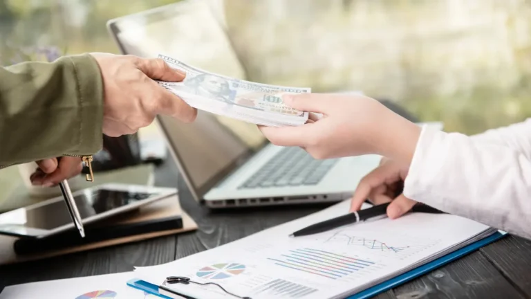 Down Payment Calculator concept showing money being exchanged during a home purchase financial planning meeting